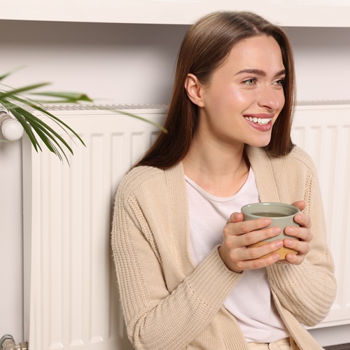 Woman in warm central heated room